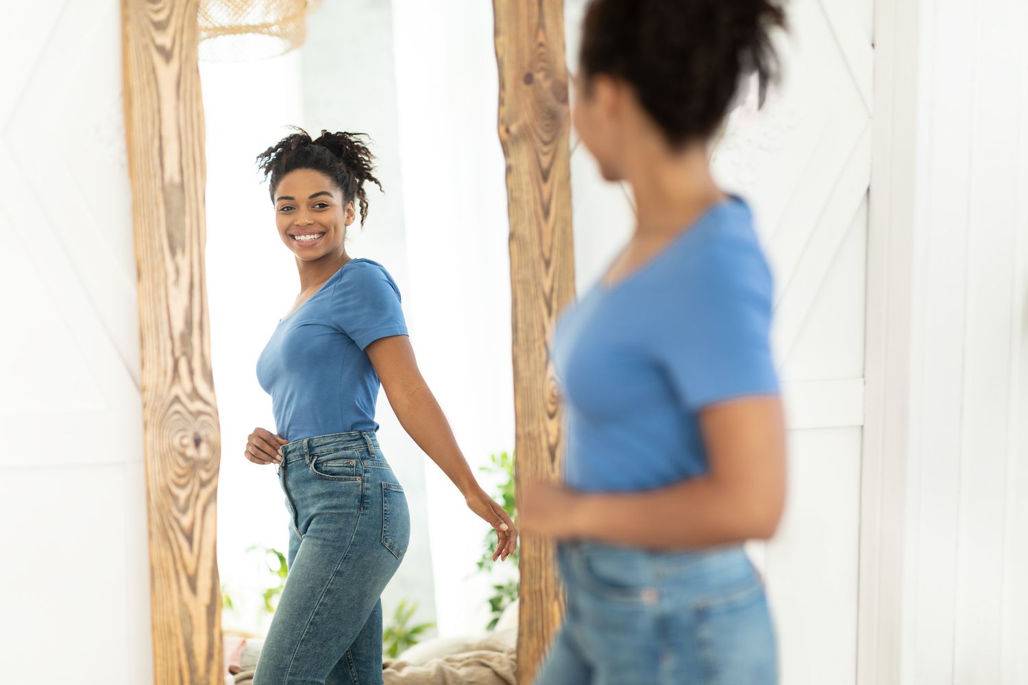 Successful Weight Loss. Joyful African American Girl After Slimming Smiling To Her Reflection In Mirror Standing At Home. Staying Fit, Dieting And Weight-Loss Concept.