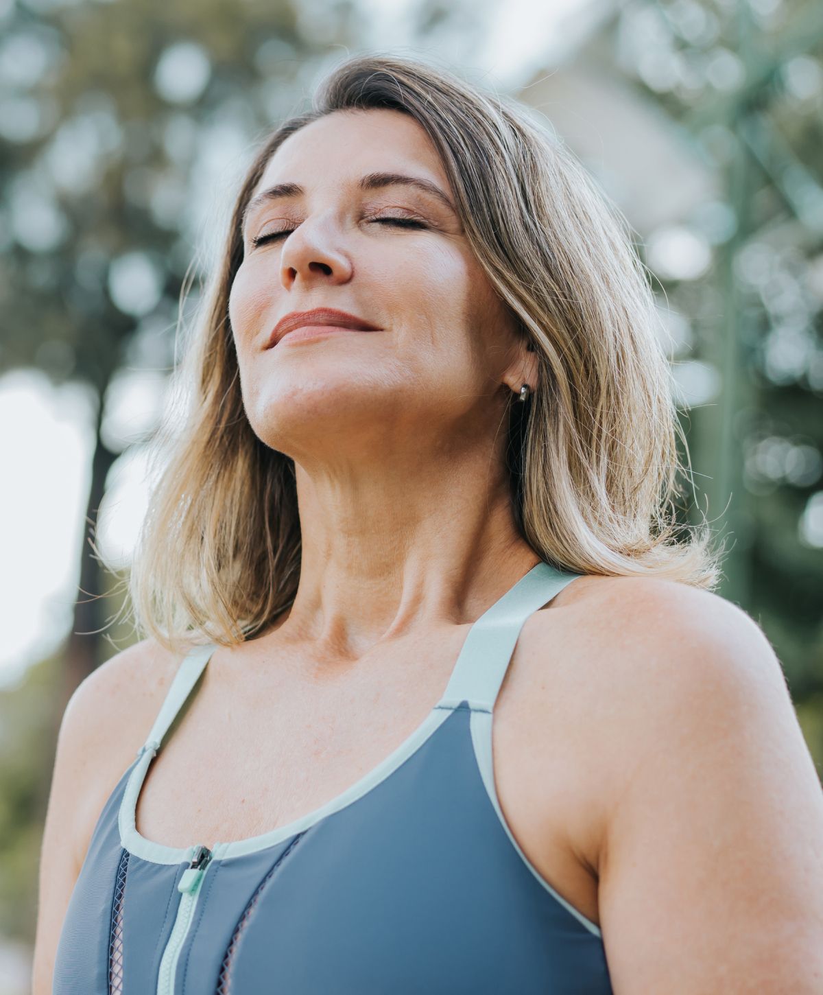 Woman practicing mindfulness outdoors with closed eyes.