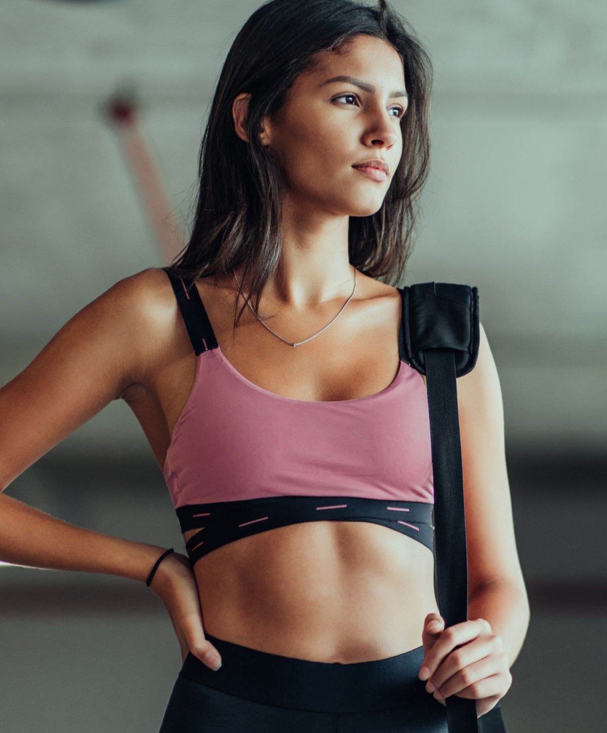 Woman in activewear looking confidently to the side.