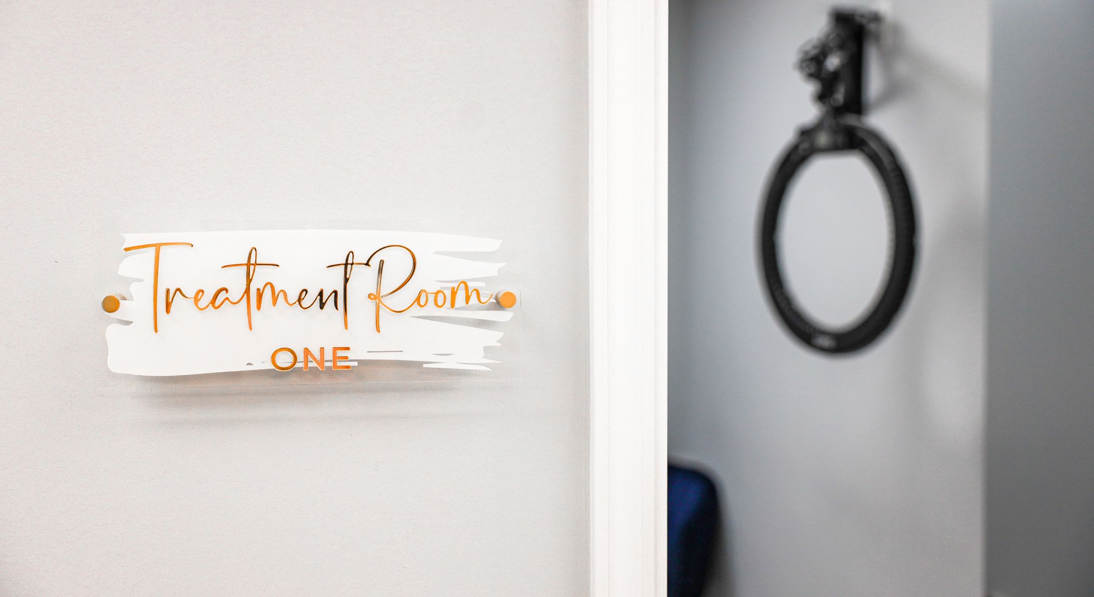 Sign for treatment room one on wall.